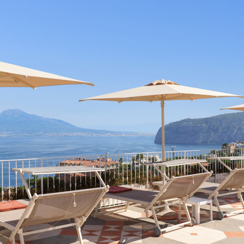 Solarium Area with Vesuvius and sea View towel and sunbeds