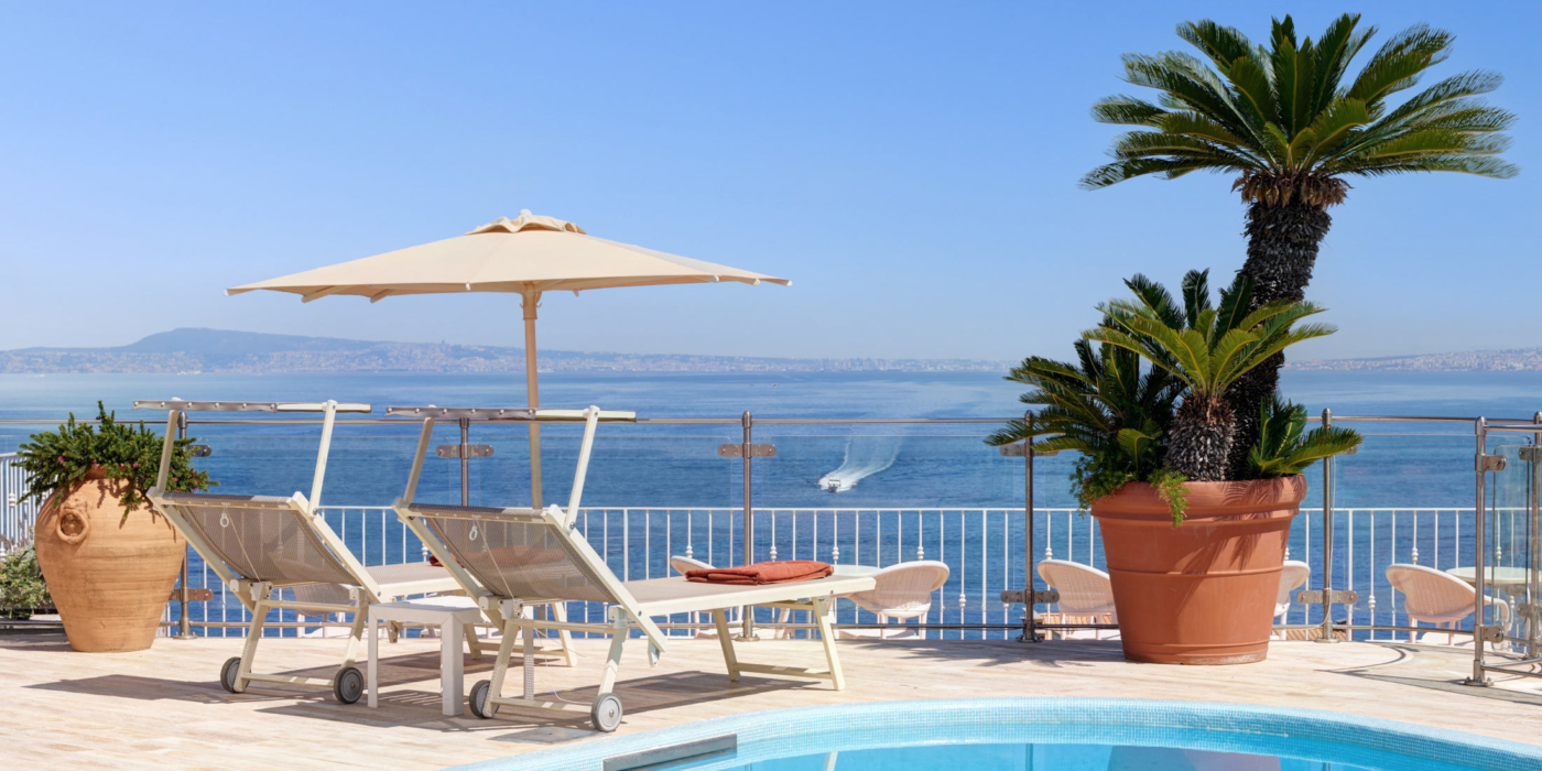 A detail of the Roofgarden with  sunbeds and the view of the sea
