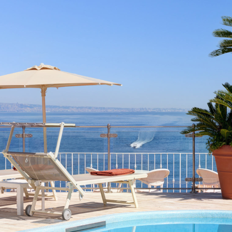 A detail of the Roofgarden with  sunbeds and the view of the sea